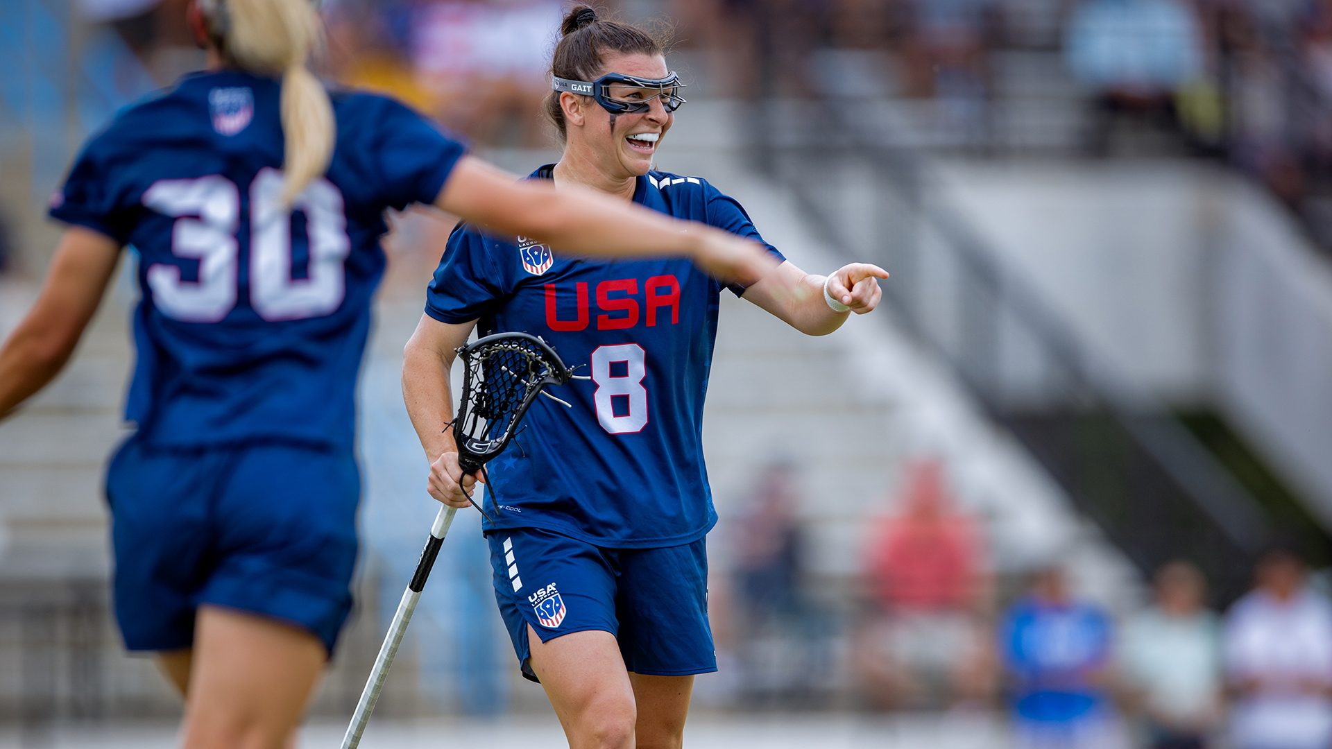 Charlotte North smiles as Ally Kennedy runs over to congratulate her after a goal.