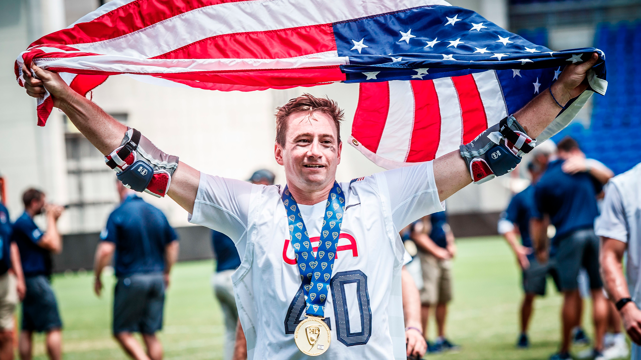 Matt Danowski holds the American flag above his head after helping the U.S. win the 2018 World Lacrosse championship